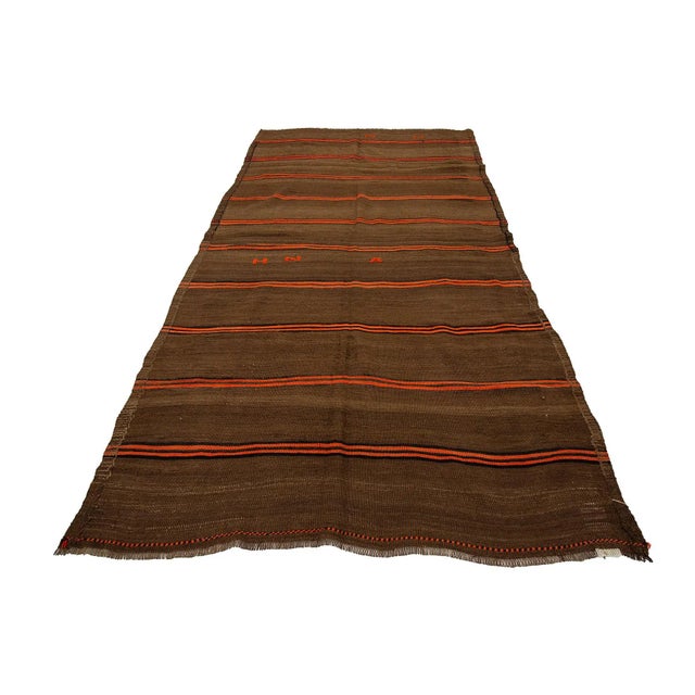 Brown handwoven vintage kilim rug from Kars region of Turkey. Approximately 50-60 years old. In very good condition