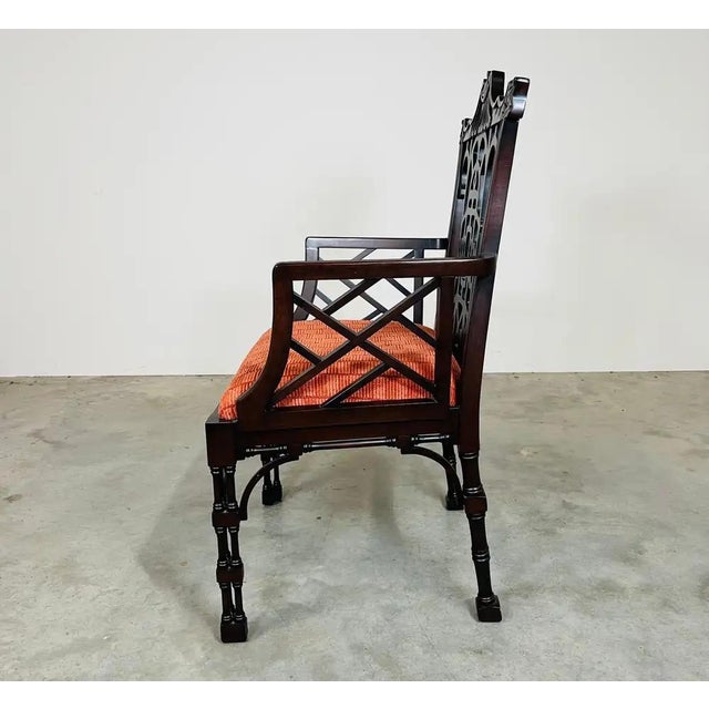 A set of 6 solid mahogany dining open armchairs featuring pagoda-crest backs, intricate openwork lattice splats, fretwork...