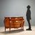 Lombard Barocchetto style chest of drawers, dating back to the early 1900s, featuring an elegant walnut and mahogany burl...