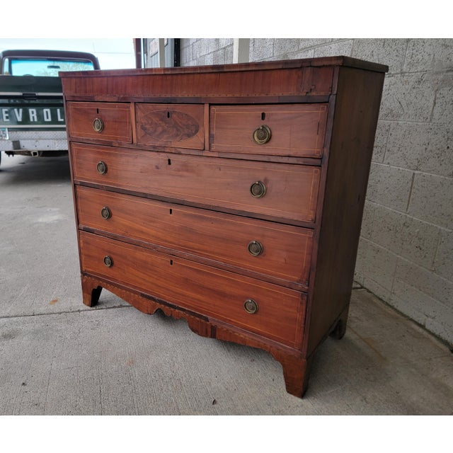 A beautiful Georgian tall mahogany dresser, circa. 1850. Elements include inlaid details, decorative oval on center drawer...