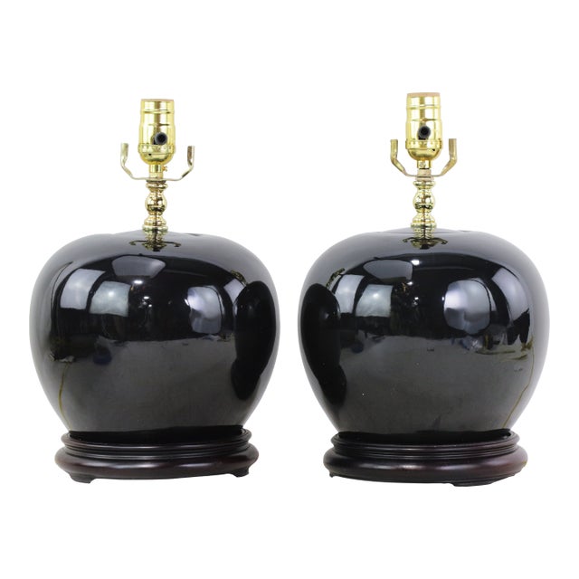 A Pair Early 20th Century Black Monochrome Porcelain Watermelon Jar Table Lamps on Carved Wood Bases For Sale