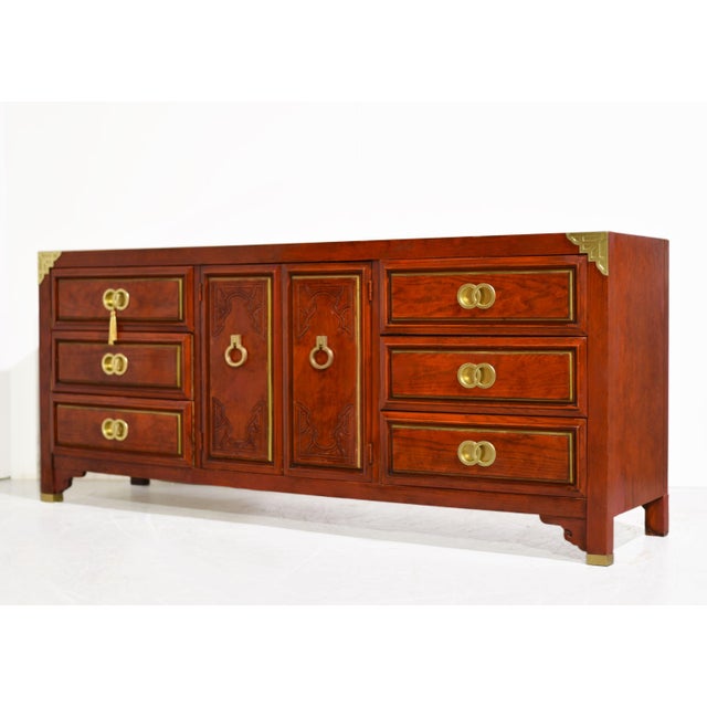 Bring polished vintage character and generous storage to your home with this 1970s Campaign-style credenza by Huntley for...