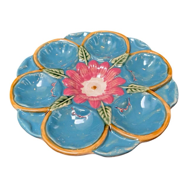 A fine antique French majolica oyster plate featuring a beautifully sculpted pink water lily at the center, set against a...