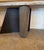 Striking console table with a dramatic solid marble cantilevered top. It has a combined cylindrical marble and geometric...