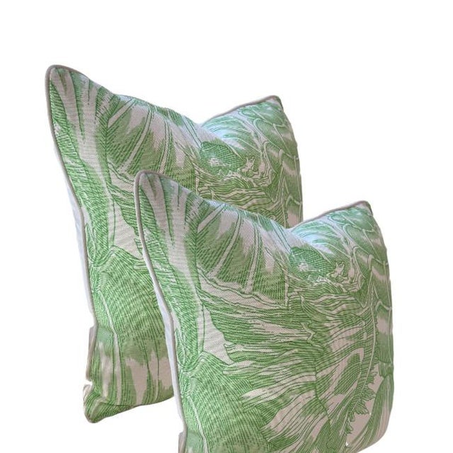 Bring the breezy beauty of the tropics into your home with this bold botanical throw pillow. Featuring a vibrant green...