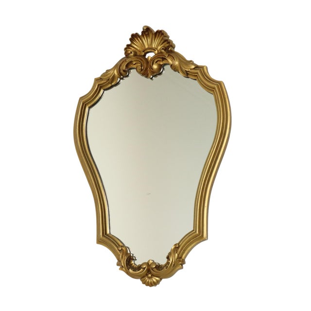 Vintage gold-colored classic mirror in Baroque style, crested mirror made of resin, decorated with acanthus leaves at the...