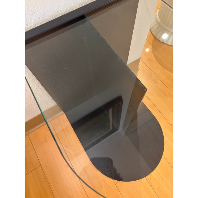 A contemporary Norah accent table by Los Angeles design studio Croft House, presented in a discontinued glass-top...