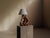 Handcrafted table lamp made from a sculpted piece of olive wood, retaining the natural contours of the material. Its...