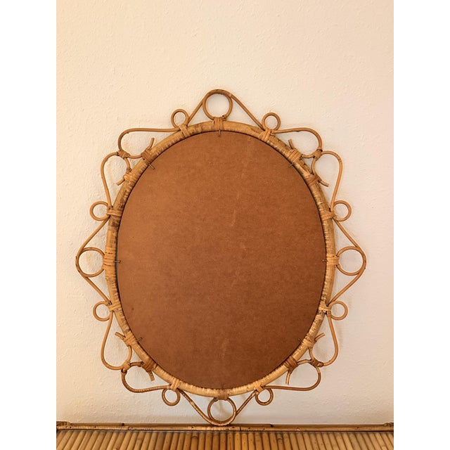 An elegant circular mirror crafted from mid-century French rattan, designed in the 1950s. Its spectacular hand-worked...