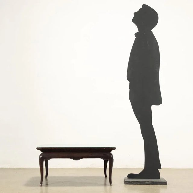 Exotic wooden coffee table with lacquered top beating with bas -relief carving depicting floral composition in the center...