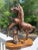 A vintage hand carved mahogany wood horse statue, Rearing up over a piece of petrified wood. Very dynamic and lifelike...
