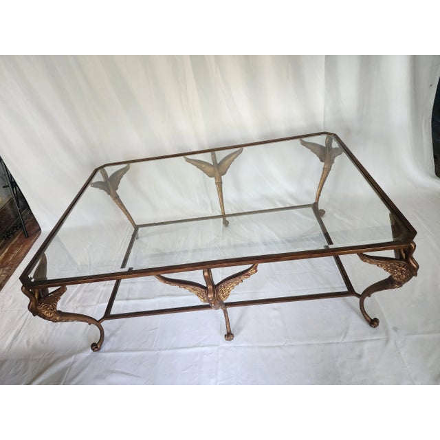 Sculptural swan figure coffee table. Two-level, with beveled glass top and lower shelf. Sturdy steel frame construction....