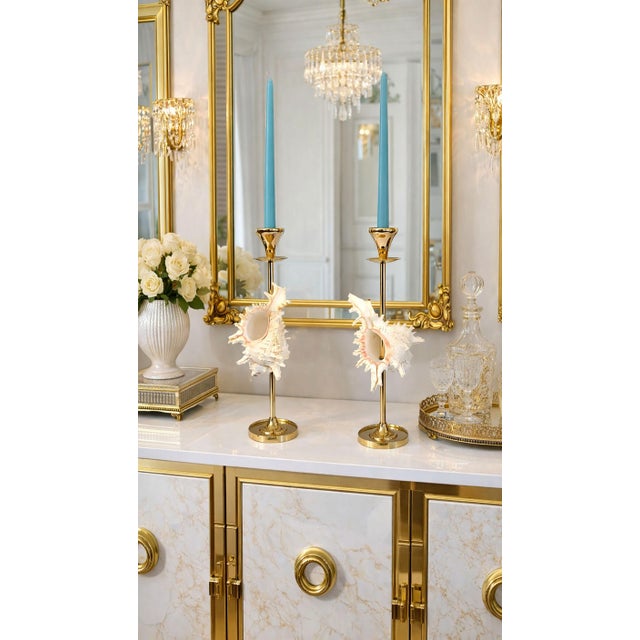 Offering a magnificent pair of restored 16.5" tall solid brass candlesticks with white seashells, circa 1960's. These...