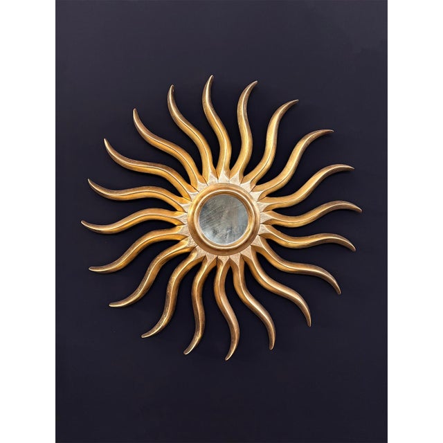 Hand-carved and gilded vintage mirror, crafted from wood and finished with traditional gold leaf techniques. It features...
