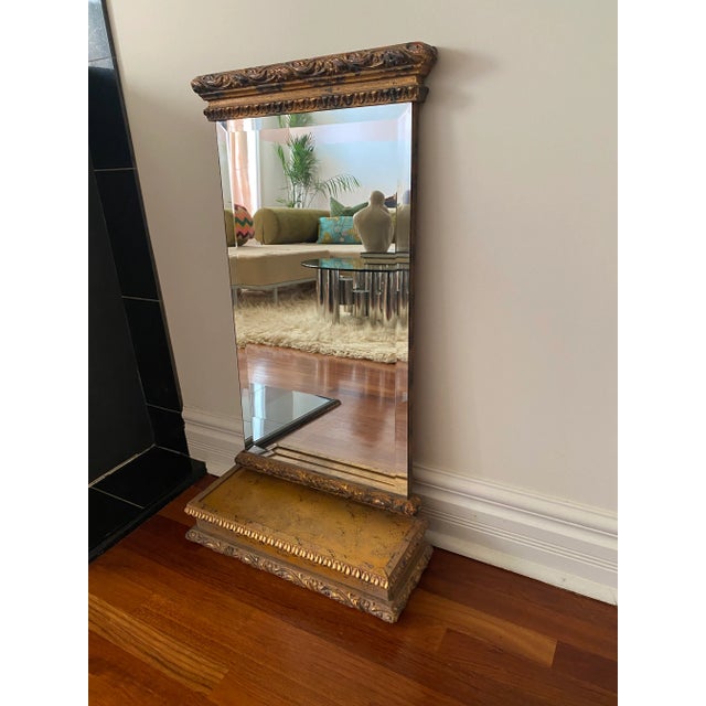 A fine vintage beveled mirror encased in gilt wood. This is two pieces with the bottom piece being a wood box with a slide...