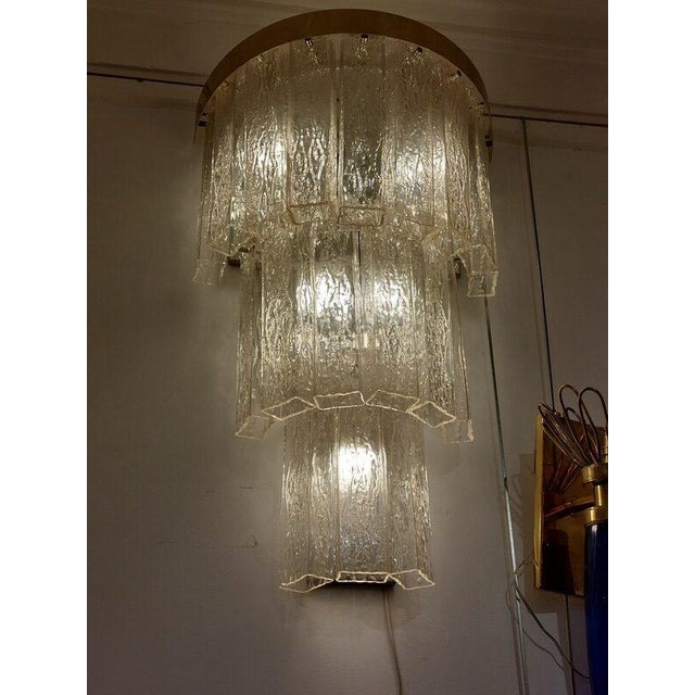 Pair of vintage Art Deco Czech crystal cascading wall lights. They feature a three-tiered, semicircular brass frame to...