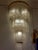 Pair of vintage Art Deco Czech crystal cascading wall lights. They feature a three-tiered, semicircular brass frame to...