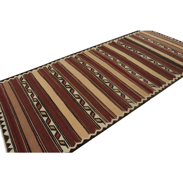 Handwoven in wool, circa 1950-1960, this 5x11 vintage Afghan tribal kilim rug is an exciting new curation in the Rug &...