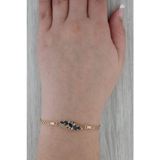 Gemstone Information: - Natural Sapphires - Total Carats - 0.97ctw Cut - Marquise Brilliant Color - Dark Blue Treatment -...