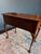 Beautiful side table in burled walnut by Baker featuring Queen Anne-style legs. Its three drawers are elevated with ornate...