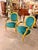 A striking matching pair of French Louis XVIstyle fauteuil armchairs, featuring richly carved gold-finished frames and...