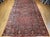 This exquisite vintage oversized Persian Sarouk rug features an allover design of grand floral bouquets in rich red tones,...