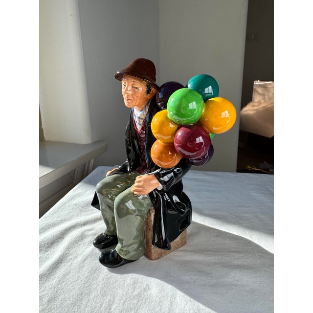 “Balloon Man” (H.N. 1954), introduced by Royal Doulton in 1950, is a finely modeled bone china figurine from the H.N....