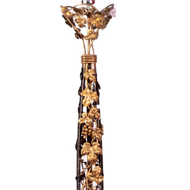 A striking early 20th Century wrought metal floor lamp, richly adorned with intricately detailed climbing ivy finished in...