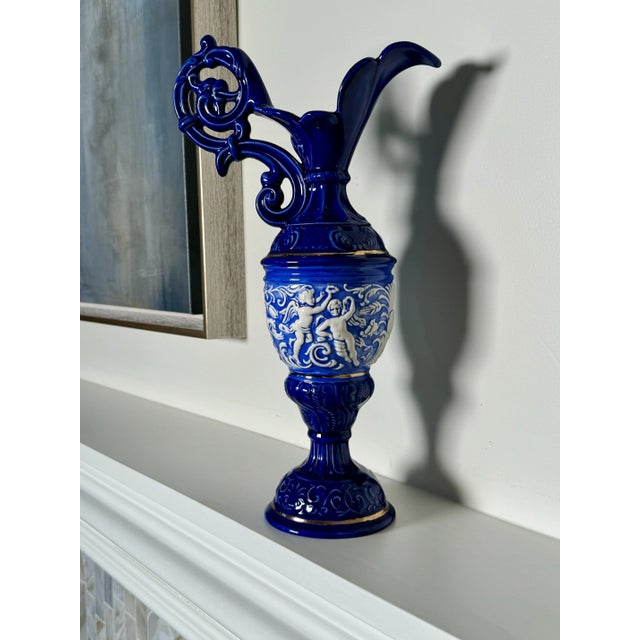 The Italian ornate Baroque style design, intricate embossing and striking colors make this decorative ceramic pitcher/urn...