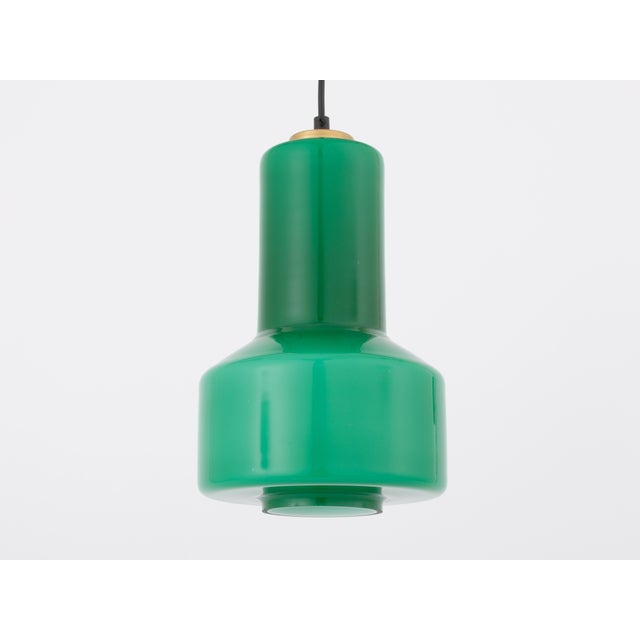 Mid-Century Modern pendant light, handcrafted in Murano around the 1950s. The glass diffuses light softly and evenly...