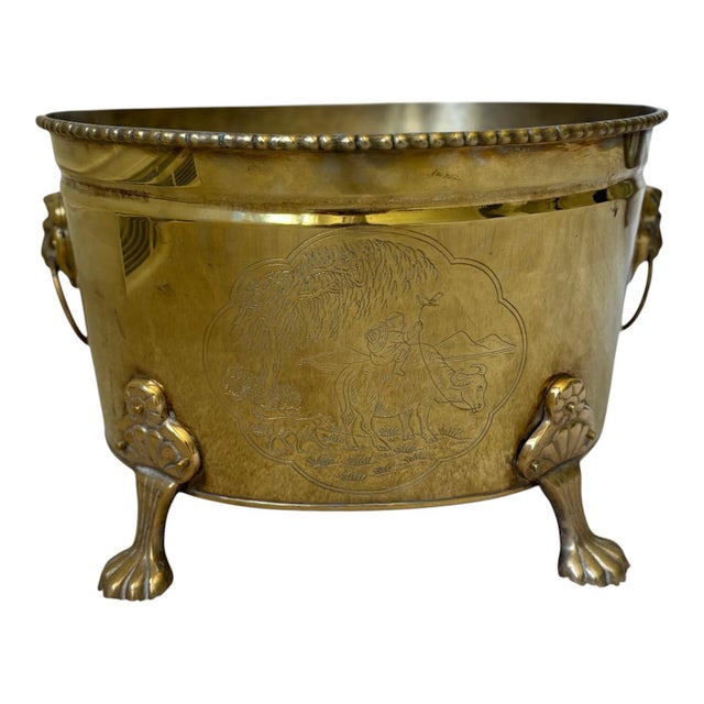 Vintage large oval cachepot featuring an intricately etched Asian-inspired scenic motifs, accented with decorative lion...
