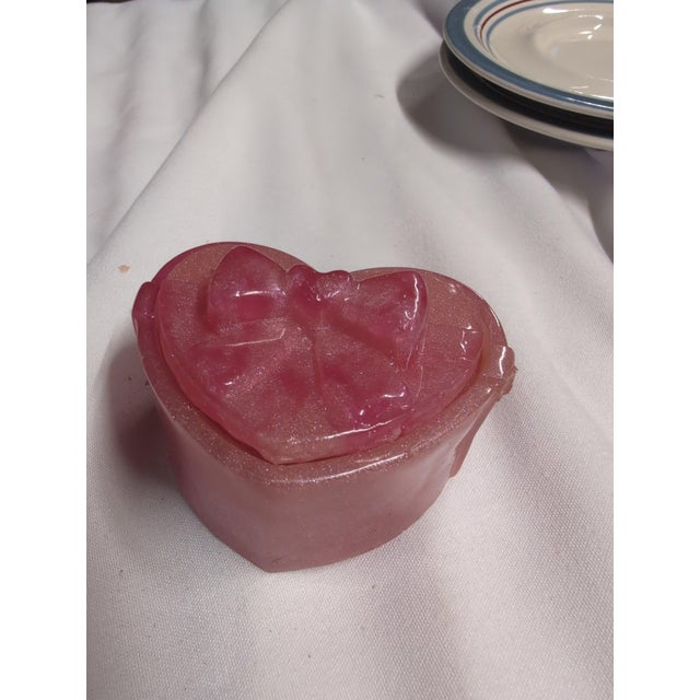 Heart-shaped decorative soap featuring a charming bow design. • Pink color with a glossy finish • Ideal for bathroom decor...