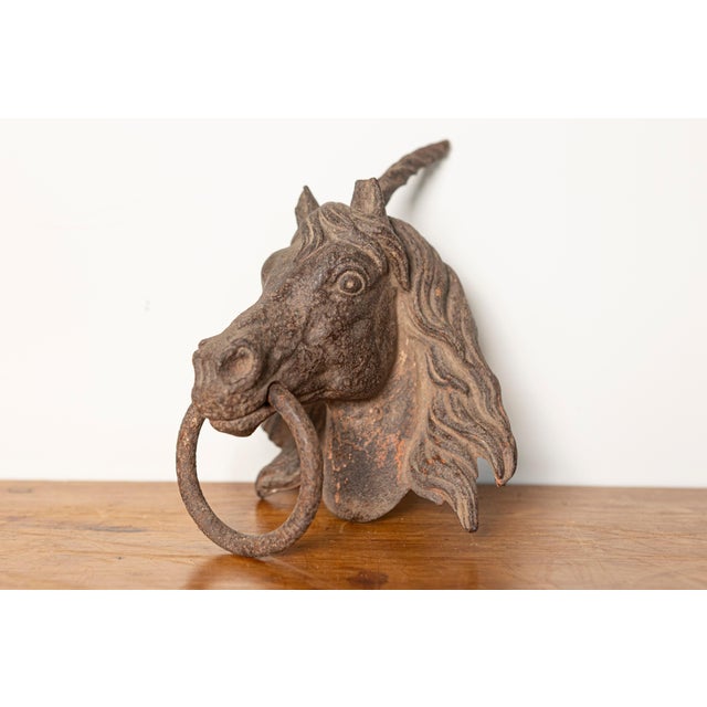 This impressive 18th-century French cast iron horse head ornament is a striking piece of architectural decor originally...