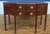 This is a 56 inch wide Hepplewhite Mahogany Sideboard by Leighton Hall. It features a classic serpentine shaped front,...