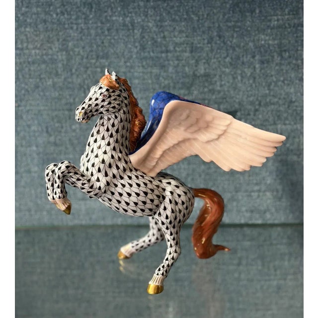 Colorful hand-painted porcelain figure depicting a standing pegasus adorned with the iconic fish scale design in black and...