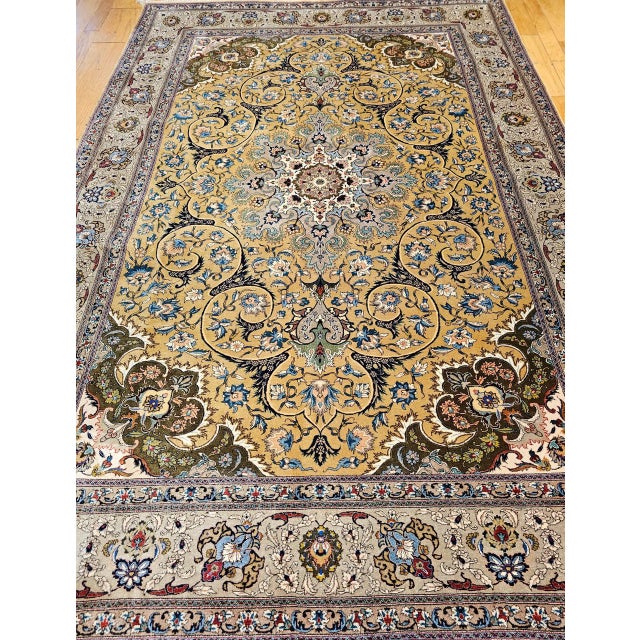 "An extraordinary early 20th century Persian Tabriz rug, room-sized and masterfully hand-knotted in a rare and striking...
