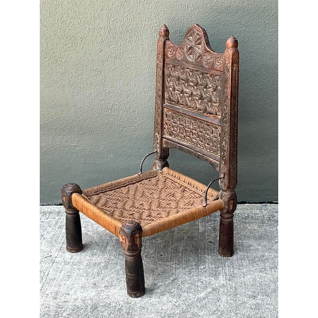 This stunning vintage low weaver’s chair is a masterclass in folk art craftsmanship and global design. Featuring an...