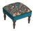 Meticulously handcrafted in the United Kingdom, this upholstered stool boasts classic studding and hand-polished solid...