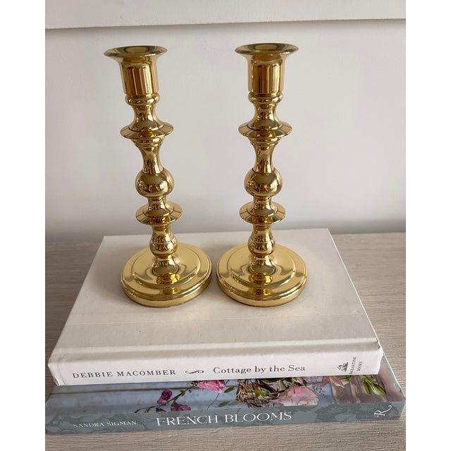 A classic pair of solid brass candlesticks by Baldwin, marked Forged in America. These candlesticks feature a timeless...