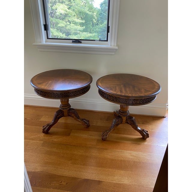 Two matching round tables featuring intricate designs. The date these were made is unknown. They were purchased in 2015.