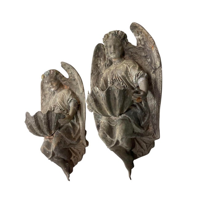 This exceptional pair of antique Continental classical cast bronze wall pockets depicts elegantly sculpted winged angels...