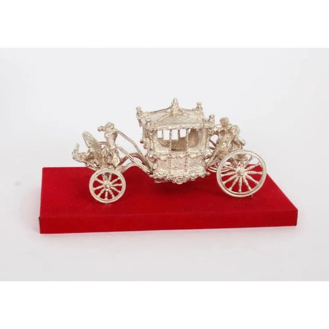 An attractive silver model of the Queen's coronation coach, hallmarked for Birmingham 1977, with the makers mark for Toye,...