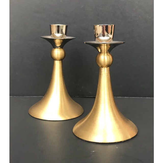 This pair of vintage candle holders has brushed gold / brass on the lower portion and shiny silver metal at the top (5.5”...