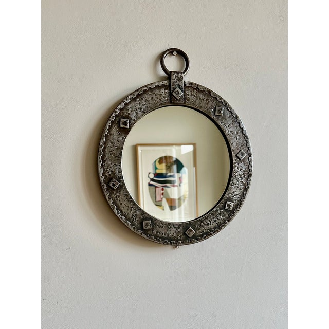 Brutalist round wall mirror from the mid 20th century, sourced from France. Hand made hammered metal frame with original...