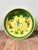 Decorative Japanese porcelain shallow bowl hand-decorated in Hong Kong with a figural scene, vibrant green foliage, and a...