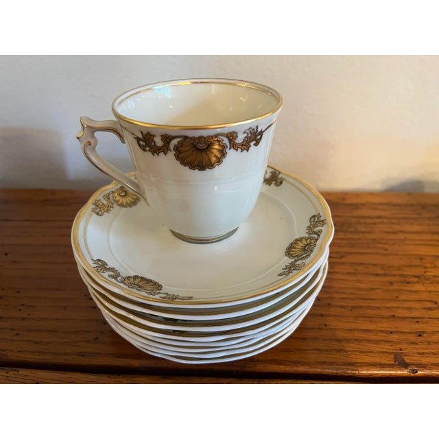 Set of 8 French Limoge porcelain cups and saucers. Bone white with elegant gold shell pattern. Traditional and classic