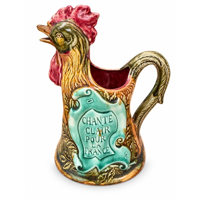 Antique pitcher from the French Onnaing factory, made of polychrome glazed earthenware (known as barbotine), depicting a...