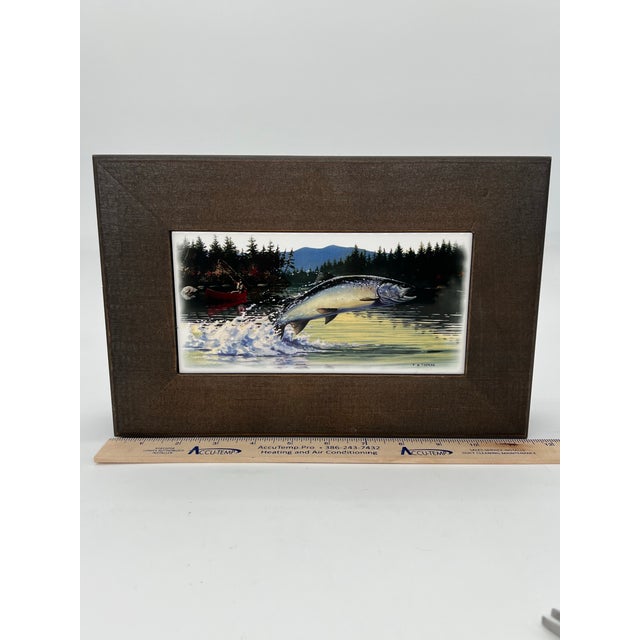 Lovely wooden box with fishing theme. The top has a tile inlay with a scene by artist F.W. Thomas. Perfect gift for the...