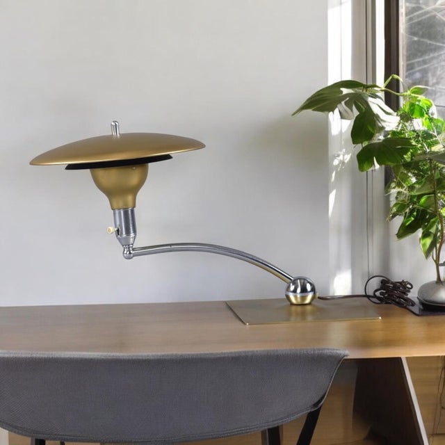 Novel mid-century modern Sight Light desk lamp by M.G. Wheeler. The space age lamp features a whimsical saucer shape. The...