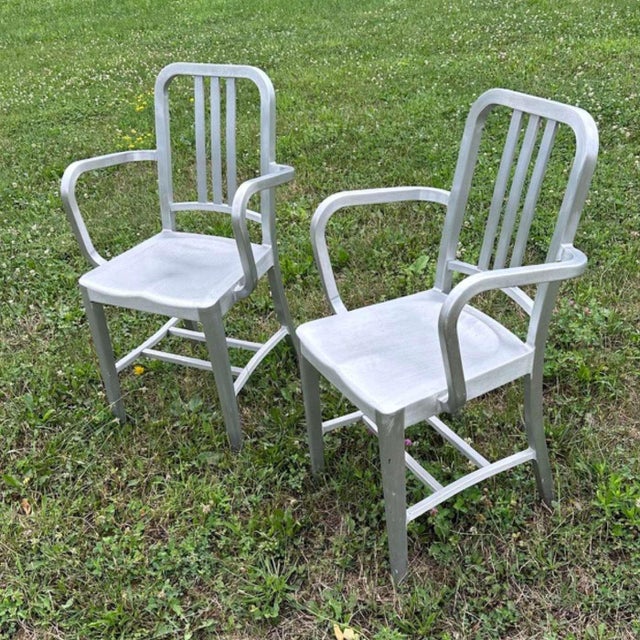 A handsome pair of authentic Emeco armchairs in brushed aluminum, dating to the 1990s. With their signature combination of...